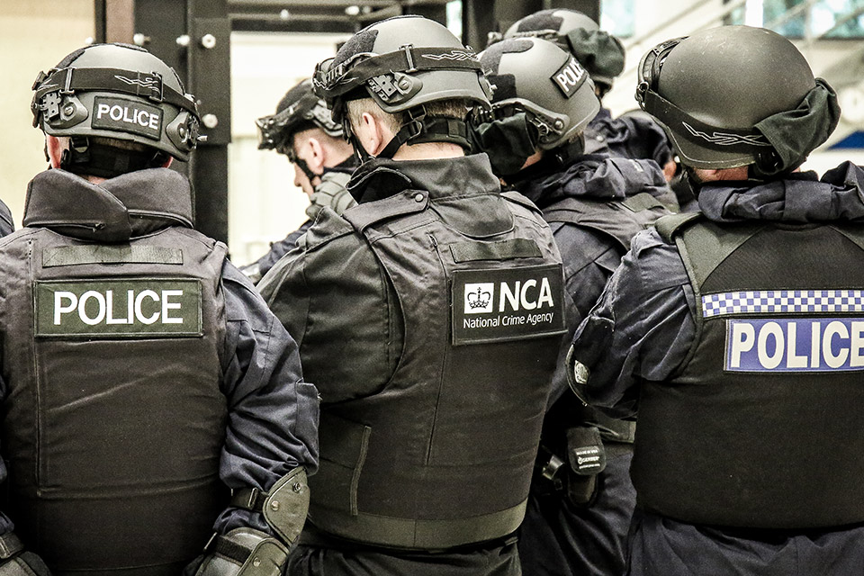 A photograph of police officers in tactical gear