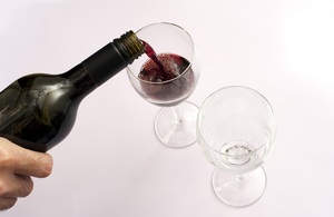 Pouring wine into a glass.
