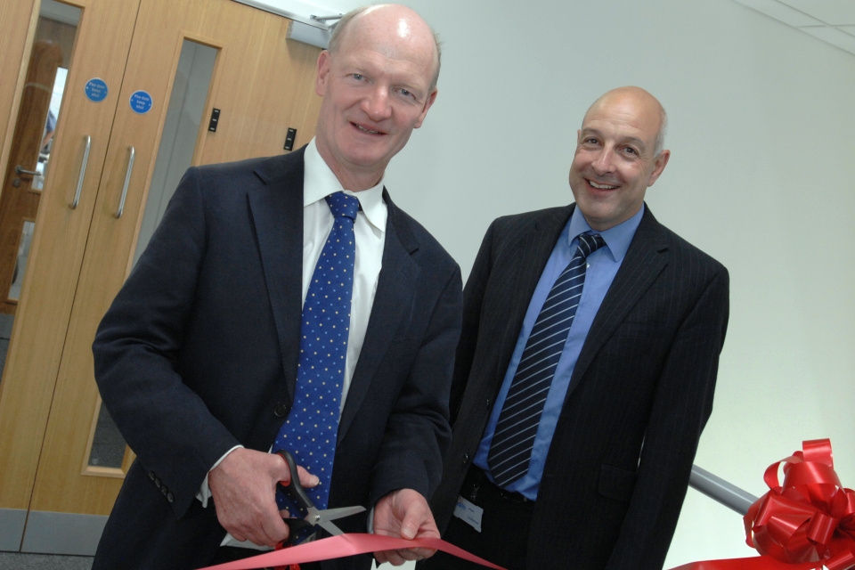 David Willetts cutting the red ribbon at Pall's new offices