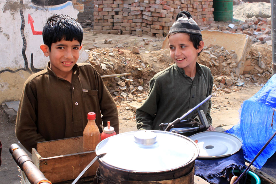 Two young boys selling food on the streets. 