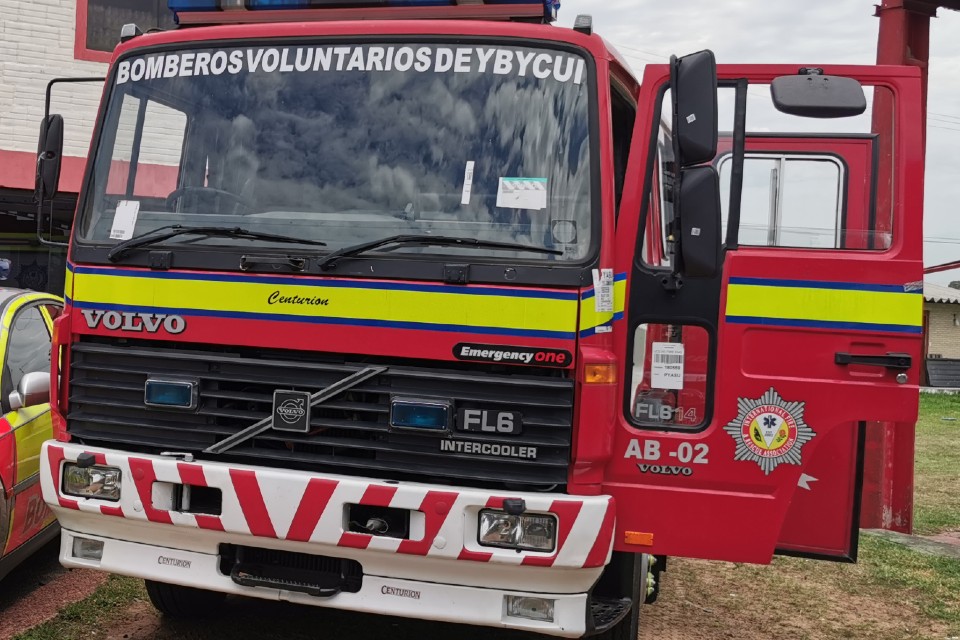 Close-up shot of the fire engine, painted in red with details and a yellow stripe