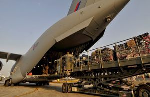 Military equipment and cargo being loaded onto an aircraft