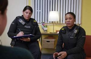 Image of 2 police officers in a room.