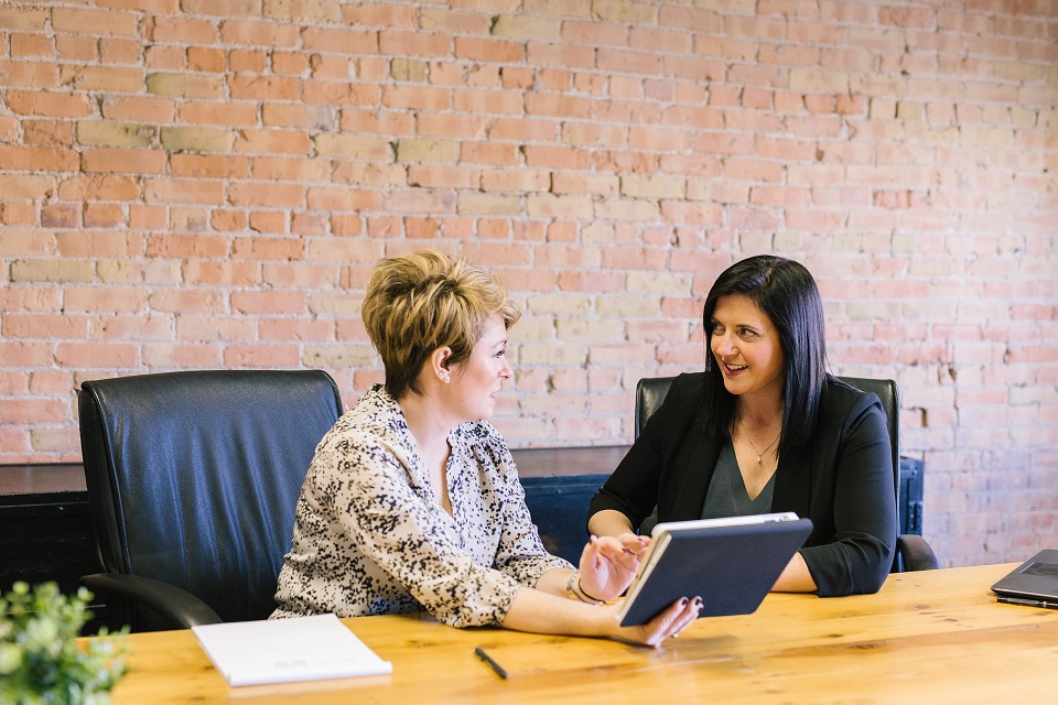 Women on Tablet Holding Meeting