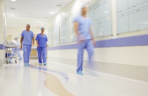 Junior doctors walking along hospital corridor