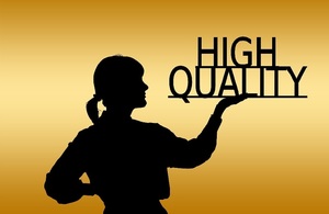 Silhouette of woman holding the words 'high quality' in one hand as if they were sitting on a tray.