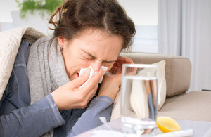 Sick woman blowing her nose