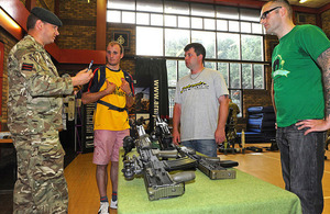 Army Liaison Officer Serjeant (spelt with a 'j' in The Rifles) Tim Lindsell talks to potential recruits about some of the small arms in use within the British Army [Picture: Richard Watt, Crown copyright]