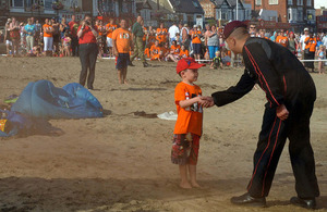 Six-and-a-half-year-old Hamish Trotter greets a paratrooper from the Ravens display team [Picture: Corporal Gabriel Moreno, Crown copyright]