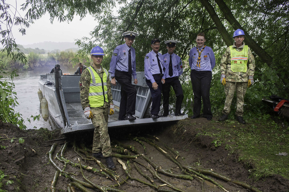 Soldiers and Sea Scouts leaders with the D-Day landing craft on Barton Island