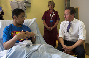 The Prime Minister talks to a patient in a London hospital.