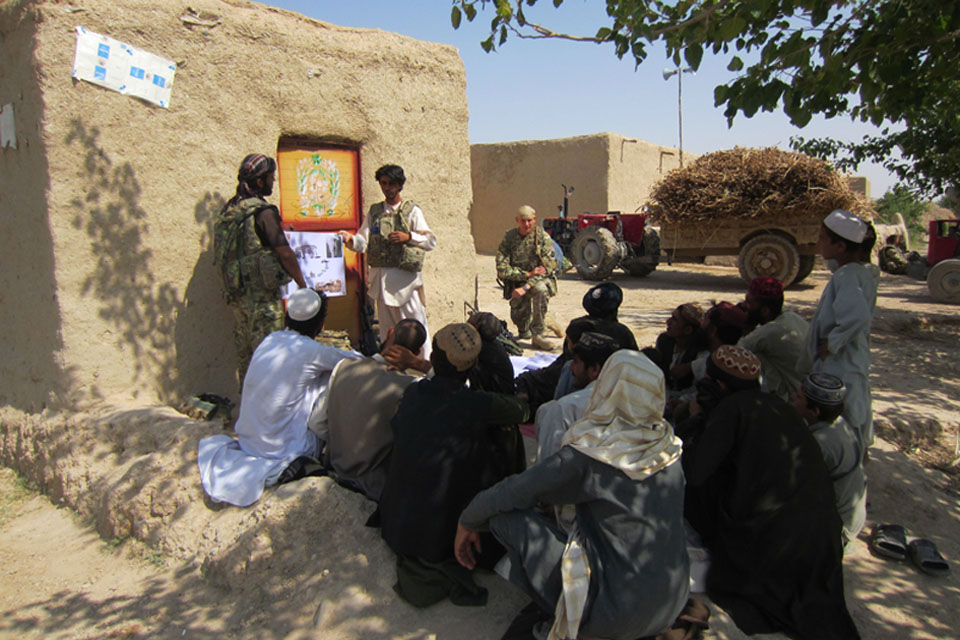 Afghan paramedic vet Jama Gul talking to local farmers about animal husbandry 