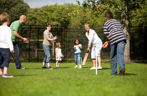 Family playing cricket