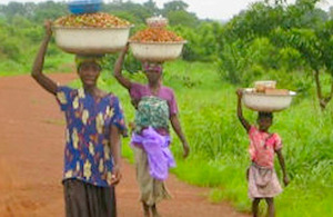 Women and children in rural Ghana walking to work