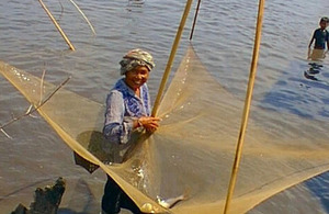 Fisherwoman with lift net in a community fishery in Lao PDR