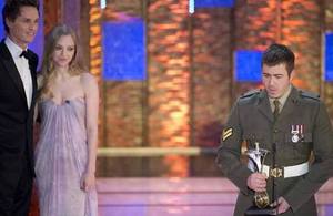 From left: Eddie Redmayne, Amanda Seyfried and Corporal Justin Morgan [Picture: Arthur Edwards, Copyright The Sun]