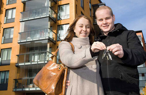 Couple holding keys.