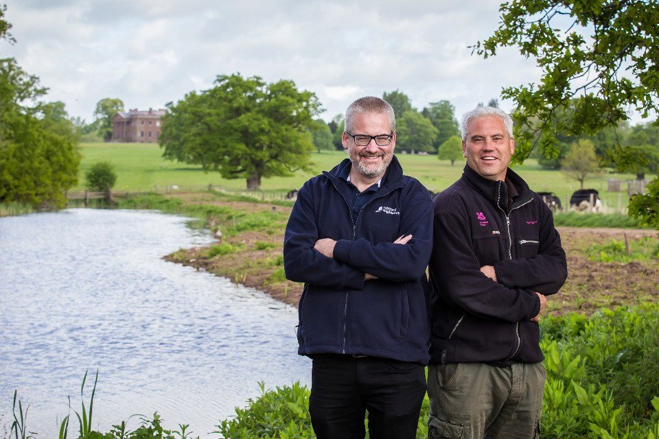National Highways Head of Service Delivery, Andy Butterfield and National Trust Countryside Care Manager Iain Carter in front of the 16-acre pool.