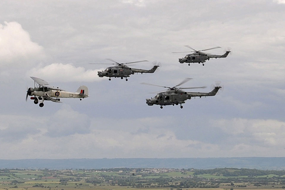 A Swordfish of the Royal Navy Historic Flight leads a formation of Lynx helicopters from 815 Naval Air Squadron