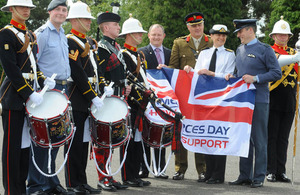 Holding the flag are Colonel Philip Bates, Commander Edinburgh Garrison, Commander Sarah West, Commanding Officer of HMS Portland, and Wing Commander Roddy Dennis, Officer Commanding 6 Squadron at RAF Leuchars