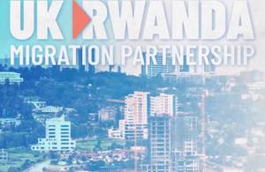 Image of buildings with text: "UK Rwanda migration partnership"