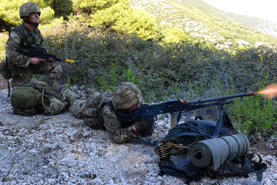 A Royal Marine opens up on an enemy position with a general purpose machine gun