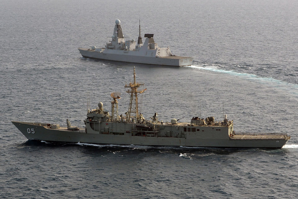 HMAS Melbourne, in the foreground, exercises with HMS Diamond