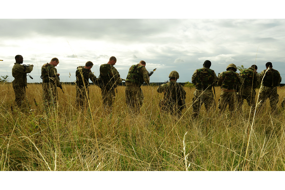 Army reservists from the London Regiment prepare their rifles for firing