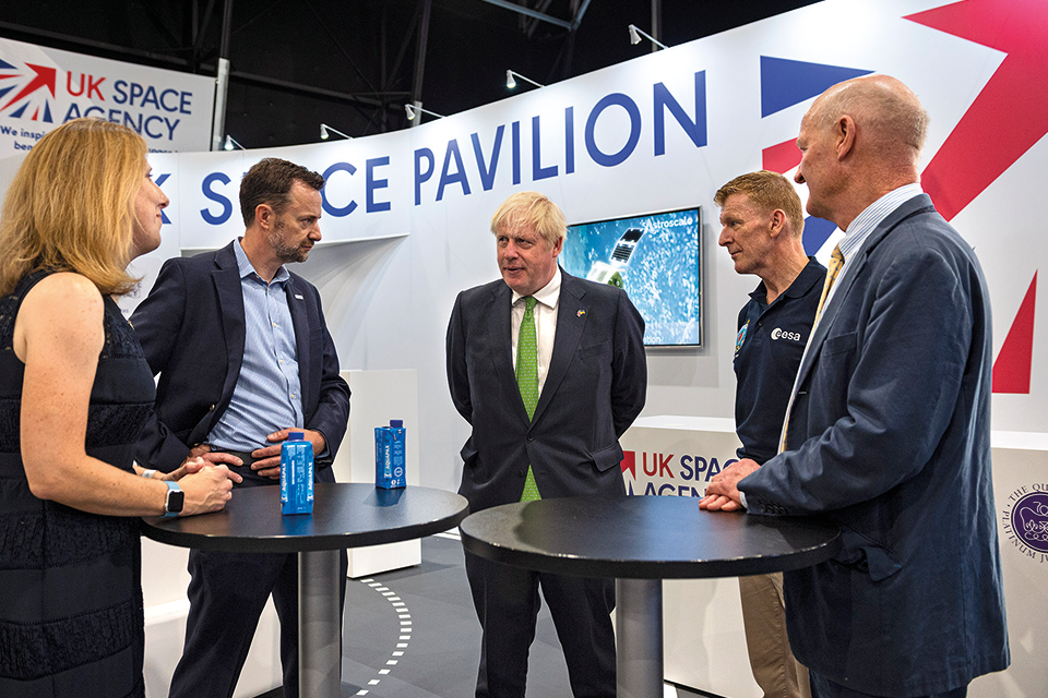 People around table at UK Space Pavilion stand