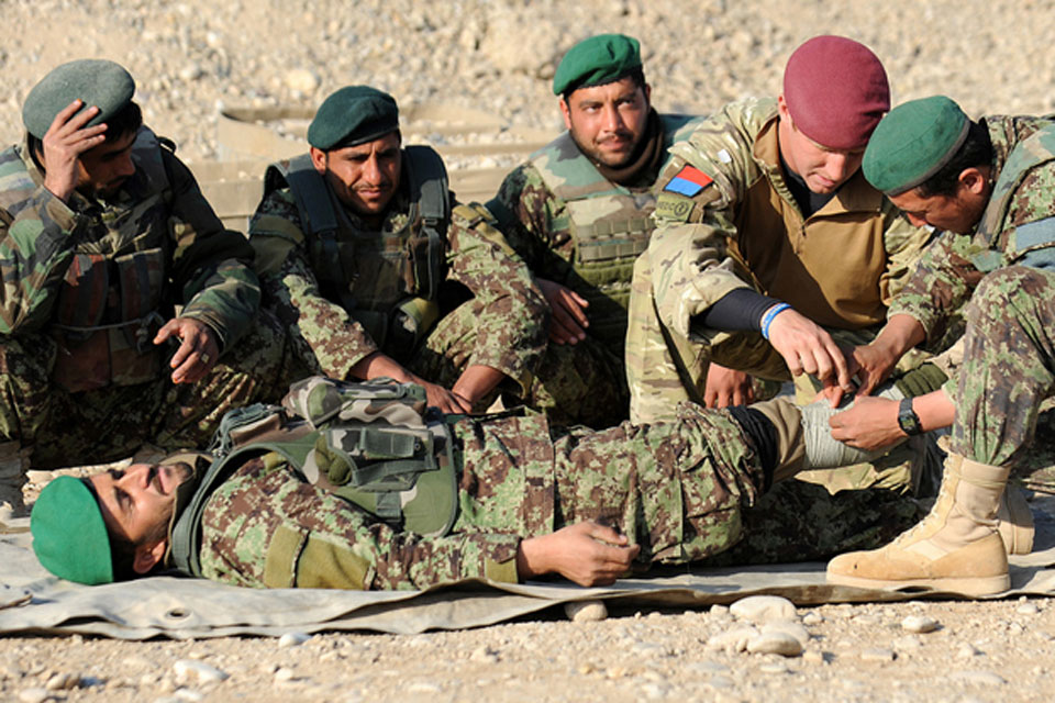 A British Army medic trains Afghan soldiers to apply field dressings