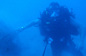 Leading Diver Ben 'Duncs' Duncan, one of the Mine Clearance Divers serving onboard HMS Ledbury, pictured with the mine just visible to his right