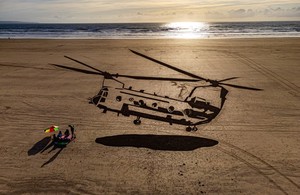 A huge drawing of a military Chinook helicopter appears in the sand on Saunton Sands beach in Devon
