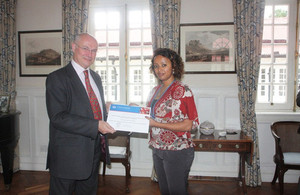 Ambassador Greg Dorey handing over certificate for 2013/14 Chevening scholar.