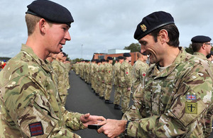 Brigadier Ivan Jones presents a campaign medal to a soldier from 26 Engineer Regiment