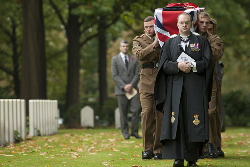 Reverend Mike Thomason, the padre of 5th Battalion The Rifles, leads the cortege of Private Lewis Curtis through the Arnhem Oosterbeek Cemetery in the Netherlands 