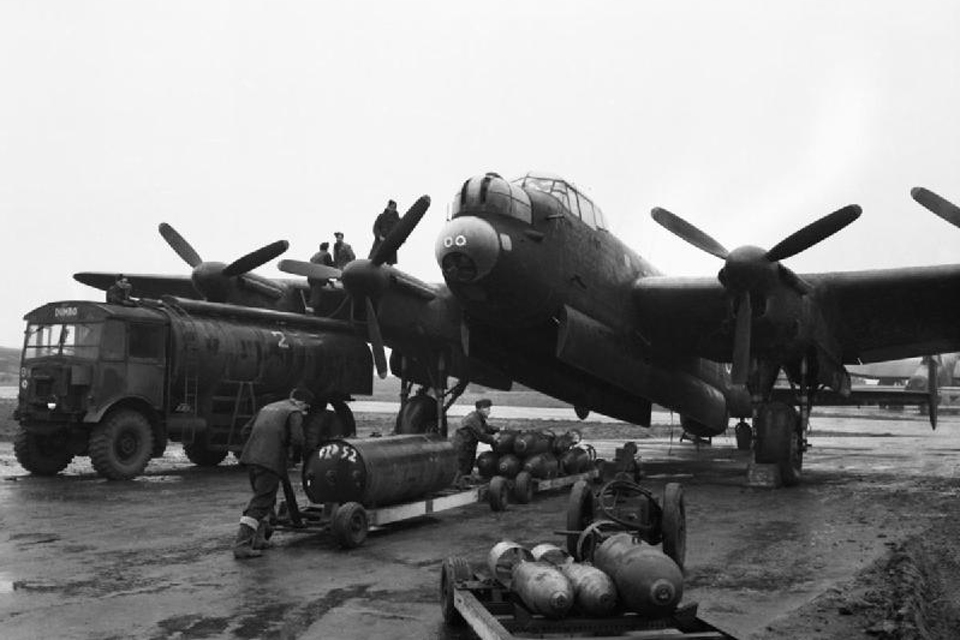 Ground crews refuelling and bombing up an Avro Lancaster of No 75 (New Zealand) Squadron