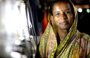 Picture of woman in India next to solar lantern