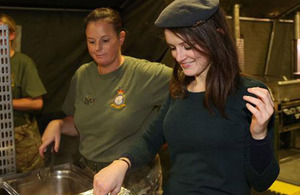 Sophie McShera, kitchen maid Daisy in the series Downton Abbey, serves up in the RAF field kitchen