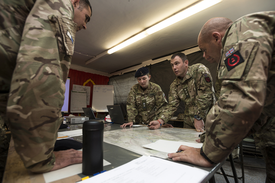  Lieutenant Colonel Dominique Cairns talks tactics with her team