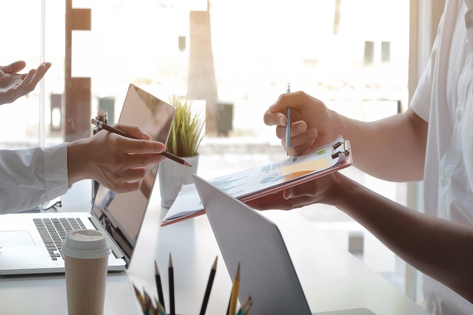 Businesswoman Holding Clipboard with Graph Paper