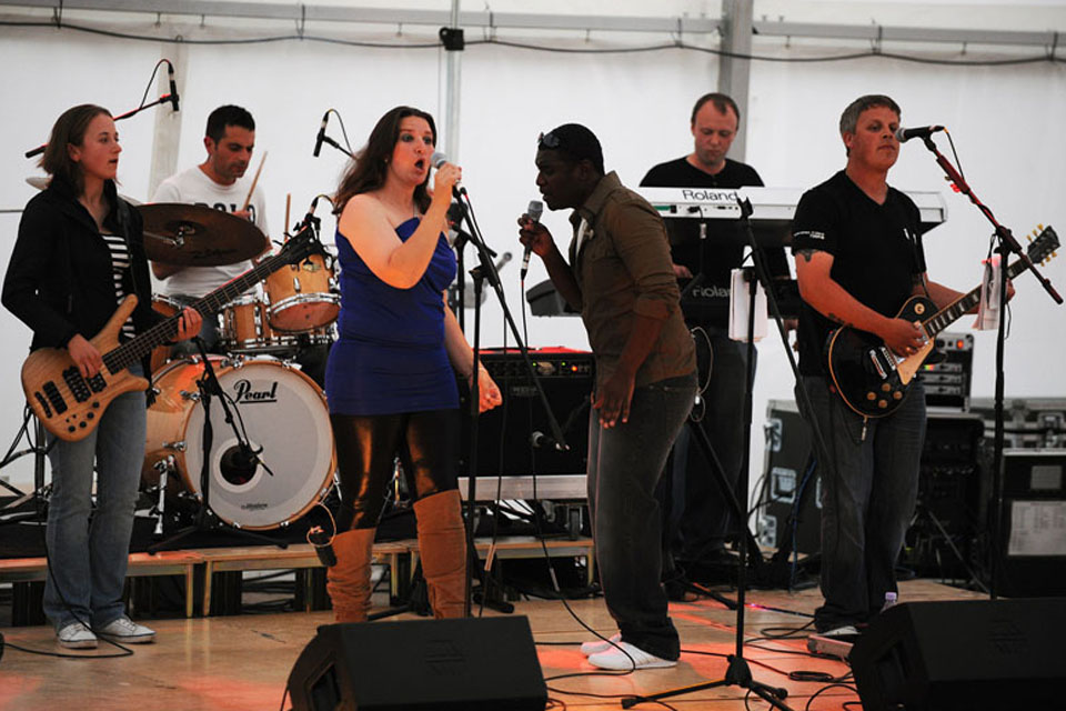 The Band of the Adjutant General's Corps' rock group 'Row 8' performing for troops living in temporary accommodation at Hainault  