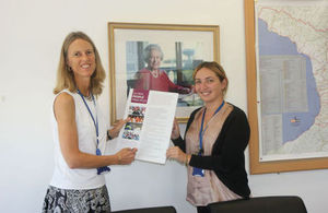 Ambassador Alexandra Hall Hall and Corporate Services Manager Tamuna Jaiani demonstrating Global Minimum Standards Poster