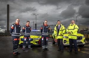 Sellafield Ltd CEO, Martin Chown and head of community and development, Gary McKeating, along with two BEEP doctors, stand in front of two new emergency vehicles. All are pictured with the Sellafield nuclear site in the background.