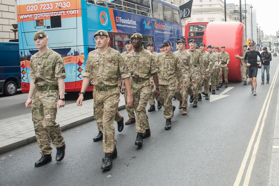 Soldiers bring the 'Stop' disk through central London 