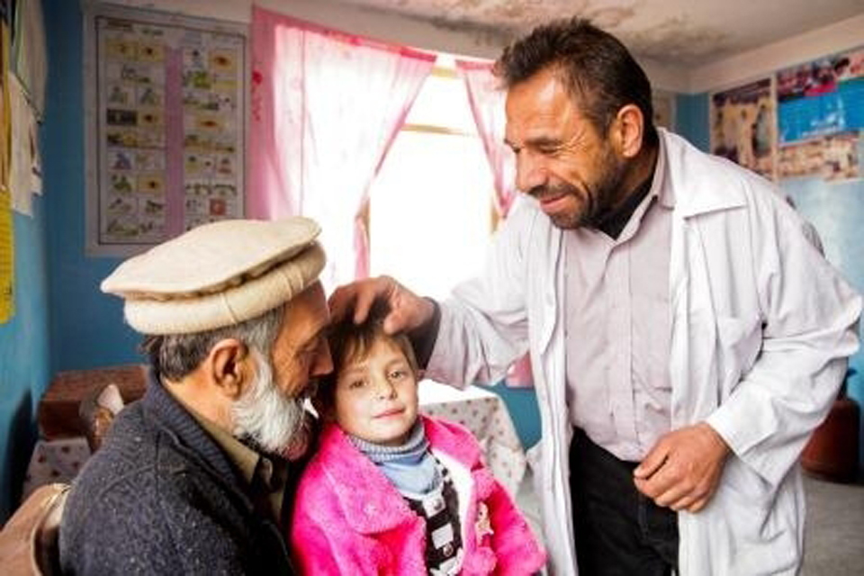 A doctor with one older and one younger patient