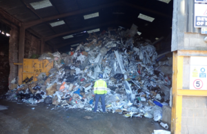 Image of Environment Agency employee standing in front of waste