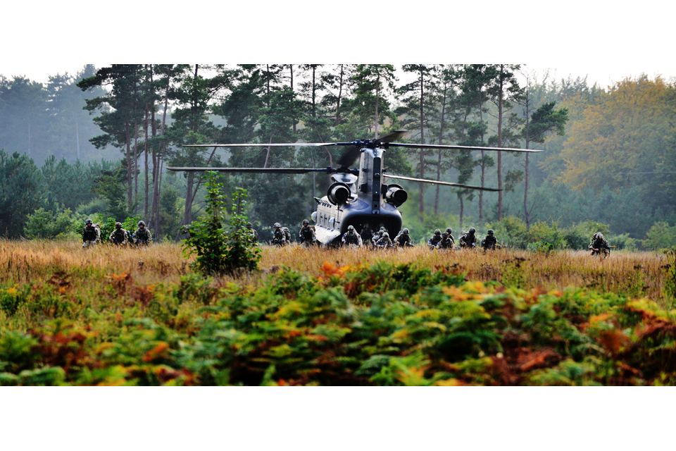 Paratroopers dismount from a Chinook helicopter