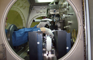 Hands working on Particle Vibration experiment