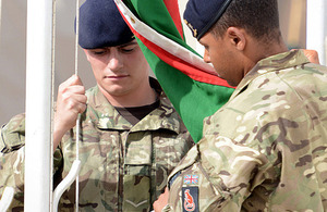 The flag of 1st Mechanized Brigade is lowered at Camp Bastion in Helmand province [Picture: Sergeant Dan Bardsley, Crown copyright]