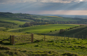 rolling hills with a gate and fencing